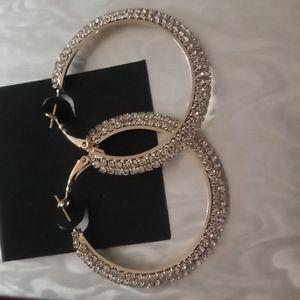 Crystal hoop earrings in gold tone.